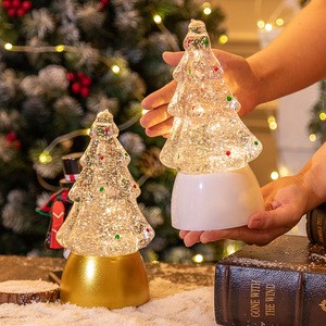 Christmas decorations: tree, crystal ball, music box, snowfall, light, gift, night