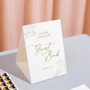 White and Gold Embossed Please Sign Our Guest Book Tent Sign - Cardstock Paper Sign for Wedding, Vacation Rentals, Hotels