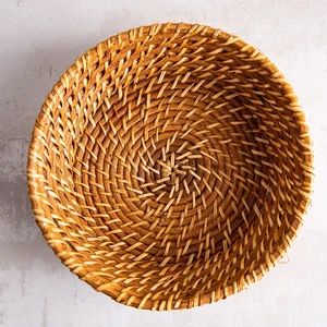 Hand woven round rattan, bamboo, water hycinth, seagrass basket for holding bread and fruit, objects. Fashionable design