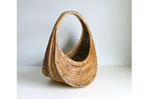 Beautiful handcrafted rattan basket with traditional weaving style for timeless rustic or farmhouse home decor