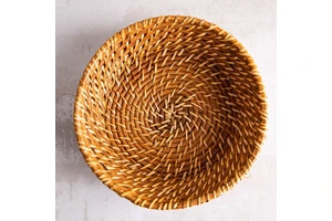 Hand woven round rattan, bamboo, water hycinth, seagrass basket for holding bread and fruit, objects. Fashionable design