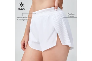 HUCAI OEM Custom Polyester Spandex Ladies Loose Split Hem Pleat Back Mesh Waistband Gym Sports Workout Running Shorts For Women